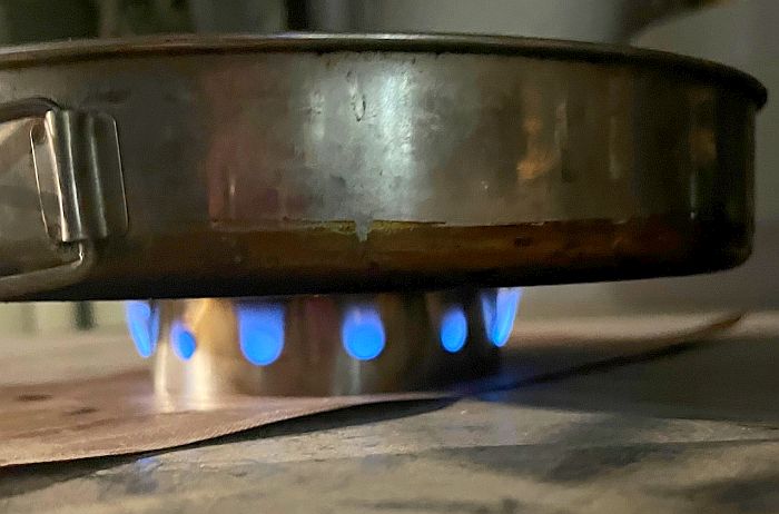 A wide pan over four Stones inside the big SimmerRing, with a ring of small blue flames
